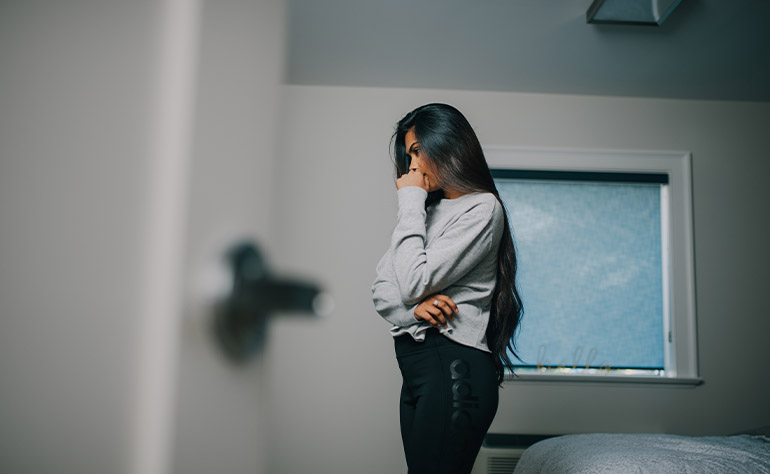 Woman client in her room grappling with depression consequences.